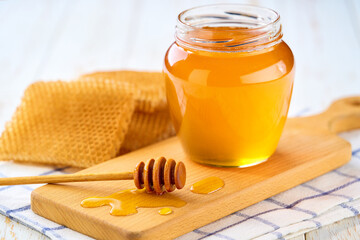 jar of nature honey on light kitchen table, selective focus. Jar of sweet honey .