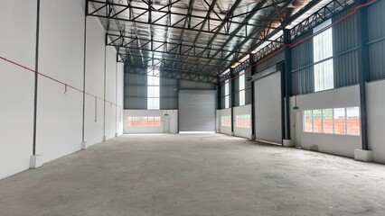 Interior view of a modern empty warehouse factory with concrete floor and high ceiling © Nazri