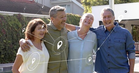 Smiling four adults in casual shirts linking arms in suburban backyard, with location-pin graphics
