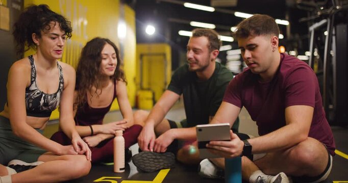 Friends gather at fitness center to share exercise tips and enjoy time together after a workout