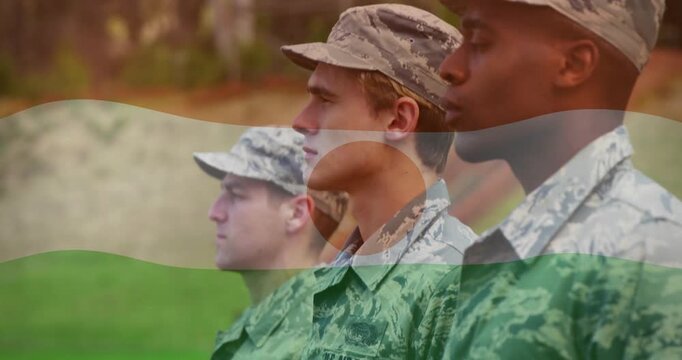 Camera panning, three airmen standing at attention in grass, flag overlay showing US AIR FORCE tape