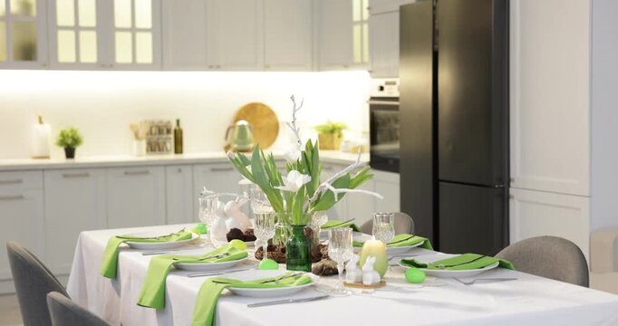 Easter celebration. Festive table setting with elegant dishware and flowers