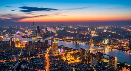Fototapeta premium City skyline at dusk illuminated buildings and river at twilight