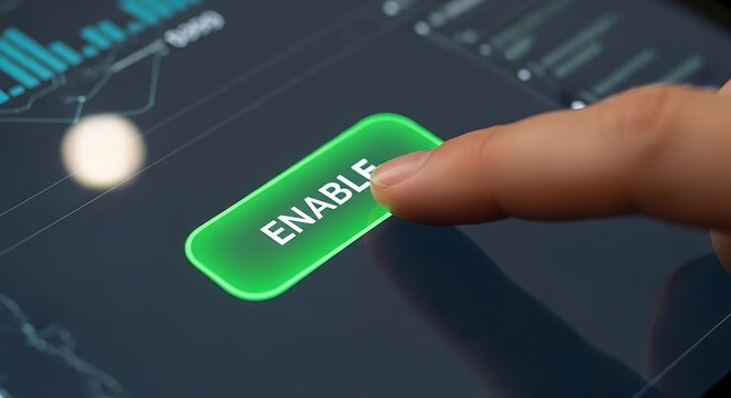 A close-up of a hand pressing a green enable button on a digital interface.