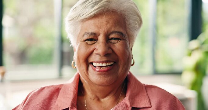 Wellness, face and senior woman in living room with laugh, positive attitude or chill in retirement. Smile, portrait or elderly person in house with good mood, happiness and peace on weekend break.