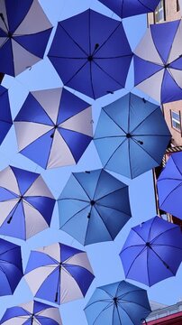 Colourful umbrellas in Old Quebec City. Tourist attractions of Quartier Petit Champlain lower town, shopping district and old French architecture