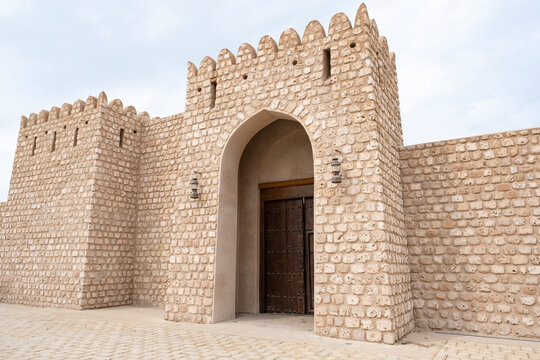 Sharjah Fort in the historic district of Sharjah, UAE. Traditional Arabian architecture surrounded by old residential houses, reflecting Emirati heritage and cultural history.