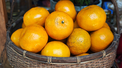 Fresh oranges in a basket.