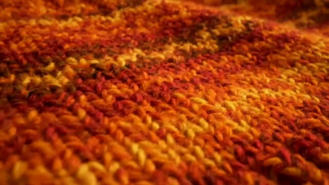 Fall Cozy Fashion knit fabric texture close-up with vibrant autumnal colors showcasing warmth and comfort through handmade craftsmanship, shallow depth of field.