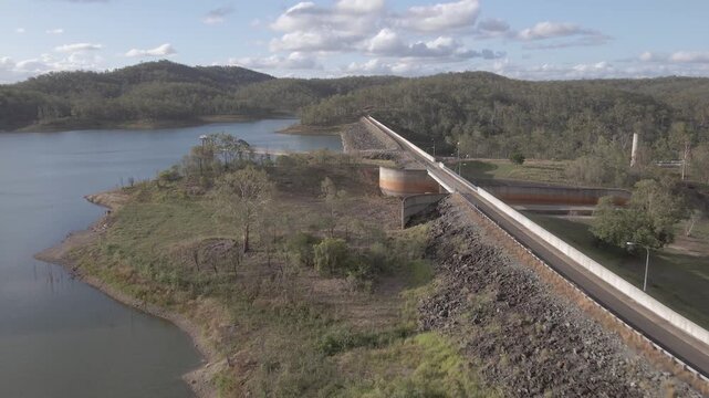 Fly towards aerial of Fred Haigh Dam in queensland Australia