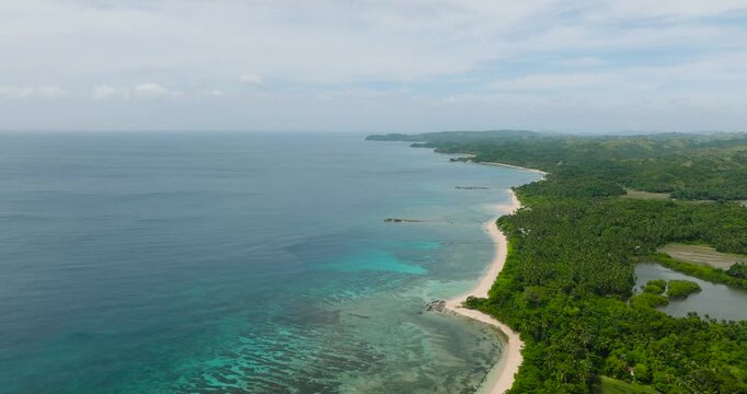 Transparent turquoise sea water with corals and white sandy beach. Santa Fe, Tablas, Romblon. Philippines.