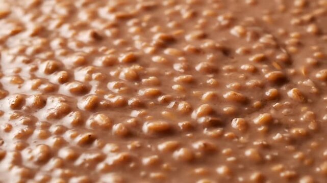 Macro Background Texture of Creamy Chocolate Porridge, Oatmeal, or Sweet Breakfast Cereal Mixture