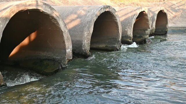The river water flows through a large sluice gate before flowing into the natural environment.