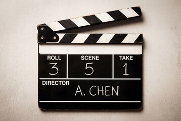 Obraz premium Classic black and white clapperboard for film production on a neutral background