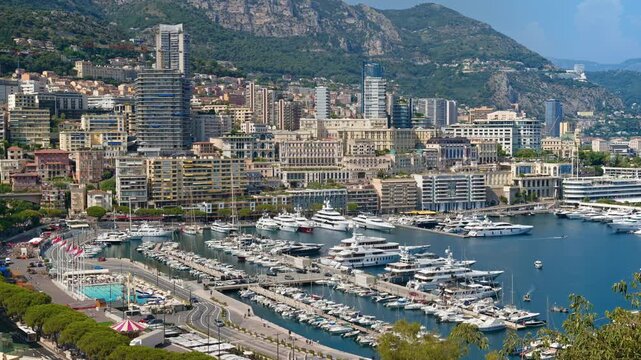 Panoramic view of Port Hercules harbor filled with yachts in Monaco city skyline