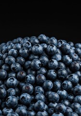A massive, fresh pile of ripe, dark blue blueberries overflowing and filling the frame, showing healthy, juicy fruit texture and color ,heap ,superfood ,wholesome