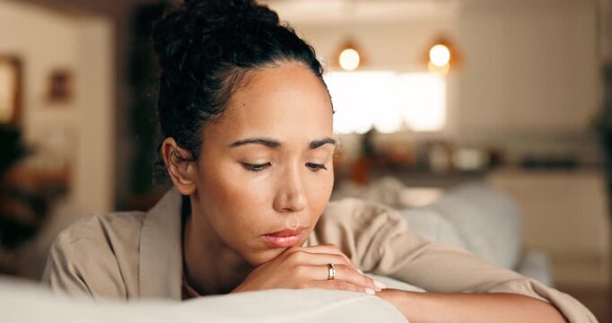 Anxiety, thinking and woman with depression in home, worry or loneliness with broken heart. Lost in thoughts, reflection and person with stress, sad and memory for breakup on sofa in living room