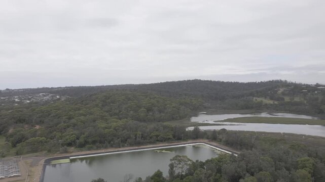 Panning aerial sewage treatment plant by ocean in Tathra Australia