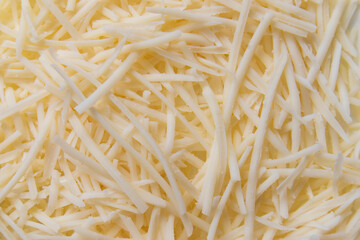 Fototapeta premium grated cheddar cheese top view