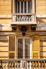 Building with timber shutters and small balcony