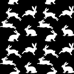 Seamless repeat pattern with white rabbit/bunny silhouettes on a black background. Minimal, high-contrast animal print ideal for textile, fabric, wallpaper, wrapping paper, nursery decor and Easter de