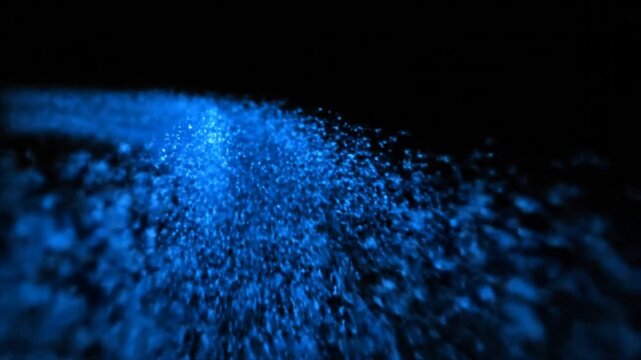 Ethereal blue light particles creating a mesmerizing, glowing flow in a deep, dark abyss
