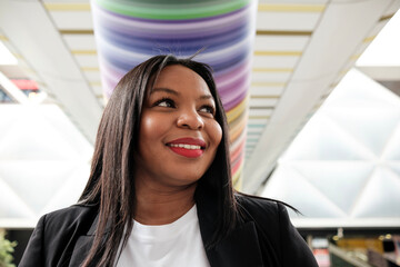 Smiling businesswoman walking in modern office building