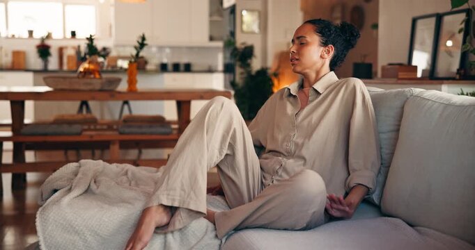 Woman, discomfort and stomach pain on couch at house from menstruation, constipation and cramps. Female person, sore and uncomfortable from appendicitis, gastritis symptoms and chronic endometriosis