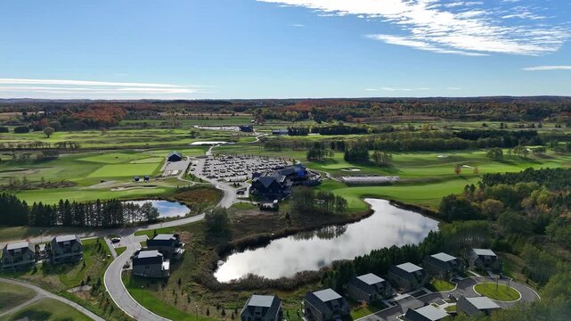 Aerial drone view of TPC Toronto at Osprey Valley Golf Course in Alton, Caledon, Ontario showing fairways, clubhouse, nearby homes and pond, host of PGA Canadian Open and home