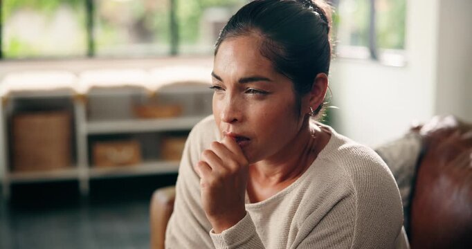 Thinking, anxiety and woman on sofa in home with worry for decision, sad memory and mistake. House, lounge and person biting nails for anxious, nervous and unsure of future, mental health and stress
