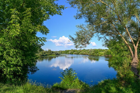 Calm water reflection of the Desna River at Andreevsky Meadow, Bryansk region of Russia