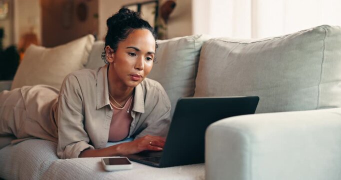 Creative, freelancer and woman with laptop, lounge and research for article, thinking and journalism. Reporter, reflection and person with tech for story on couch, typing and remote work in house