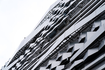 Obraz premium modern Aluminium composite material architecture gray color and Hexagon shape popup texture on exterior facade building.