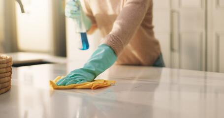 Person, hands and cleaning surface with detergent in kitchen for housekeeping or hygiene in home....