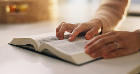 Person, hands or reading with bible for holy study, religious belief or christianity in home. Closeup, christian and learning faith with gospel or book of god for religion, worship or praise in house