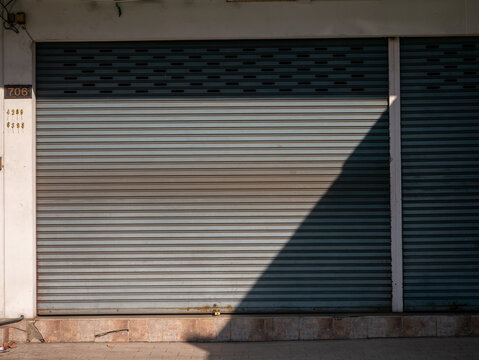 Closed Shop with Metal Rolling Shutter Door and Shadow