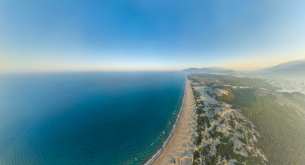 Fototapeta premium Gelemis, Turkey. Morning waves on Patara Beach, mediterranean sea and sandy shoreline in summer, panoramic aerial perspective. Aerial view