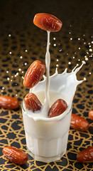 Top View High Speed Splash of Dates Dropping Into Fresh Milk