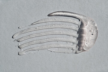 Transparent skincare product swatched creating streak on light surface