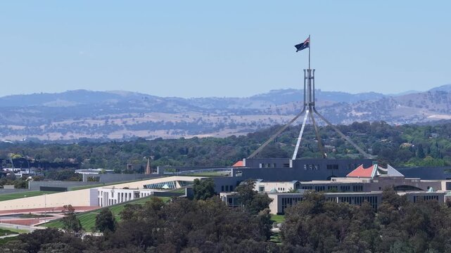 Australian Parliament House and Flagpole Under Clear Blue Sky in Canberra