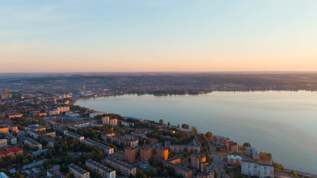 Russia, Votkinsk. Embankment with a dam and factories. Votkinsk is a city in the Udmurt Republic. Sunset time. Drone footage