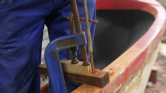 Drilling into boat gunwale using spade bit to mount oarlocks
