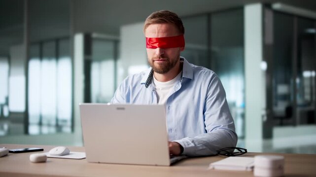 Blindfolded Businessman Struggling With Computer