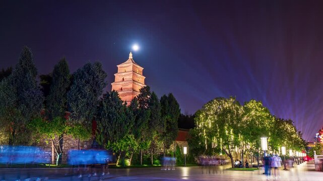 Historic Pagoda at Night with Moon and Colorful Plaza Lights