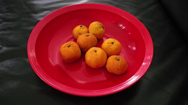 red apples in a bowl,Fresh mandarin orange fruits, Indonesian called Jeruk Santang Madu,Chinese New Year celebration