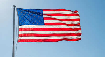 Obraz premium American flag waving on a flagpole against a clear blue sky with sunlight shining from behind