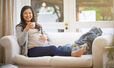 Obraz premium Portrait, pregnant woman and relax in home with coffee, peace and touch stomach on weekend break. Happy, female person and beverage in living room with pregnancy, rub belly and ready for motherhood.