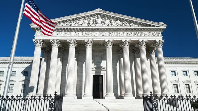 White marble building with columns and flag