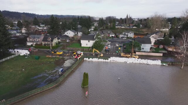 Sandbags Used As Flood Barrier Along Swollen White River In Pacific, Washington. aerial shot