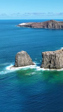 Majestic volcanic cliffs of Roque Farallon meeting the deep blue Atlantic Ocean in Gran Canaria